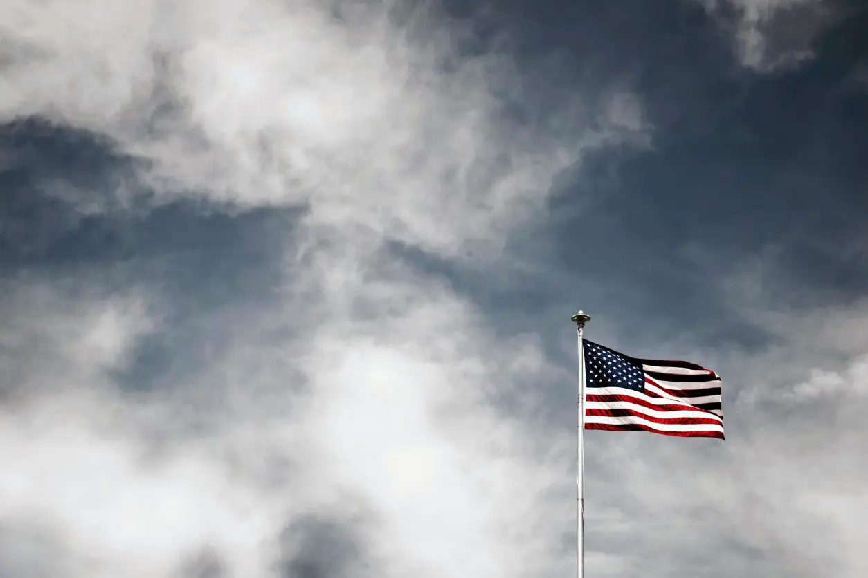 A flag flying in the sky on top of a pole.