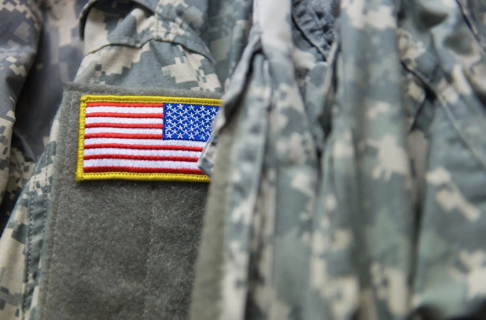 A close up of the american flag patch on a military uniform.