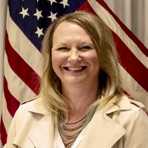 A woman in front of an american flag.